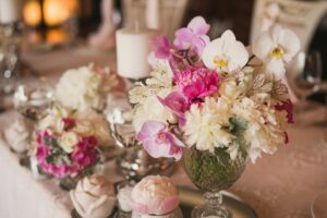 Floral compositions and candles on the decorated dining table.